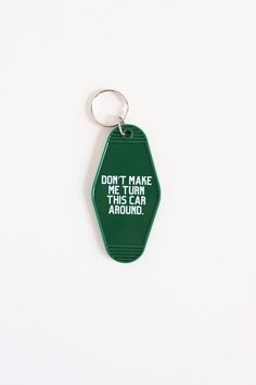 a green keychain that says, don't make me use this car around