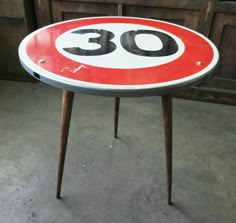 a table with a sign on it that says 30 in the center and is next to a door