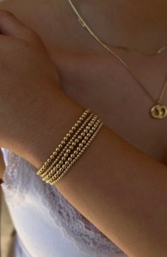 This curated stack consists of a mixture of 5 signature bracelets (2) 2MM Yellow Gold Filled Beaded Bracelets (3) 3MM Yellow Gold Filled Beaded Bracelets DETAILS: 14k Yellow Gold Non-tarnish & water safe Size: 5.75-8", XXS-XXXL 6.5 is the average size! Strung on an elastic cord, offering a slight stretch Roll on & off your wrist gently to preserve longevity Handmade in Los Angeles NO Discount codes are eligible for use on ANY bundled stacks, as they are already discounted Adjustable Yellow Gold Stackable Beaded Bracelets, Adjustable Stackable Yellow Gold Beaded Bracelets, Stackable Adjustable Yellow Gold Beaded Bracelets, Gold Stackable Jewelry With Round Beads, Adjustable Stackable Yellow Gold Bracelets, Stacked Bracelets With Round Beads, Stackable Yellow Gold Bracelets For Everyday, Stackable Yellow Gold Bracelet For Everyday Wear, Dainty Stackable Beaded Bracelets In 14k Gold