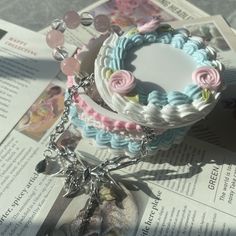 a bunch of bracelets that are on top of a newspaper with beads and charms