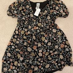 These Colors Could Go Either Way! Dress This Up With Black Leggings And Boots, Or Wait Till The First Day Of Spring With The Muted Spring Pastels! This Dress Is Adorable! While It Is A Large It Runs On The Smaller Side! Black Floral Dress With Short Sleeves For Spring, Black Puff Sleeve Dress With Floral Print, Black Ditsy Floral Print Dress For Summer, Black Ditsy Floral Dress For Summer, Black Summer Dress With Ditsy Floral Print, Chic Black Dresses With Ditsy Floral Print, Black Printed Mini Dress For Day Out, Black Floral Short Sleeve Dress For Beach, Black Floral Short Sleeve Beach Dress