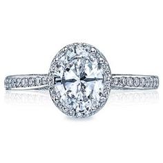 an oval cut diamond ring with pave set shoulders