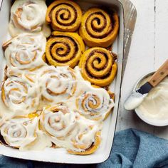 cinnamon rolls with icing in a baking dish