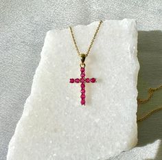 "A timeless and classic design, symbolizing love, commitment and wealth. Perfect for everyday wear or dressed up for special occasions. Rubies are said to symbolize the sun, while its glowing hue suggests an inextinguishable flame within the stone. Add a pop of color with our Genuine Ruby Round Cut Cross Pendant, available in 14k solid white gold and 14k solid yellow gold. 14k solid white gold and 14k solid yellow gold chain available for additional purchase to match your beautiful pendant.  Item Specifications: Materials: 14k Solid Gold  Gemstone: Natural Rubies Pendant Diameter 20 mm x 10.7 mm Total Gold Weight: 0.61 ct. Total Rubies Weight: 0.31 ct.  Necklace: Adjustable 16 and 18 inches with a lobster clasp Chain Weight: 0.6 mm 1.35 grams  ★  Each order will be beautifully packaged in Ruby Cross Pendant, Spiritual 14k Gold Gemstone Jewelry, Symbolic 14k Gold Gemstone Jewelry, Spiritual Yellow Gold Jewelry With Gemstones, Symbolic Gemstone Jewelry For Formal Occasions, Tarnish Resistant Spiritual Cross Jewelry, Symbolic Yellow Gold Jewelry For Valentine's Day, Spiritual 14k Gold Birthstone Jewelry, Symbolic Yellow Gold Cross Jewelry