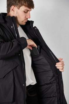 Stay warm this winter with the Men's Winter Hooded Parka Cargo Long Sleeve Coat. This stylish coat is crafted from durable material to provide protection against cold temperatures and is designed with a hood for added warmth. It features cargo pockets for storage and a drawstring waist for a customizable fit. This chic zip down jacket features removable faux-fur trim along the hood so you can wear it as needed to keep you comfortable and cozy. The winter jacket features adjustable sleeve opening Hooded Down Winter Outerwear, Hooded Down Outerwear For Winter, Windproof Winter Outerwear For Cold Weather, Windproof Outerwear For Cold Weather, Winter Outerwear With Double-lined Hood For Outdoor Activities, Hooded Windproof Winter Outerwear, Windproof Hooded Winter Outerwear, Winter Down Outerwear With Double-lined Hood, Winter Sports Outerwear With Detachable Hood