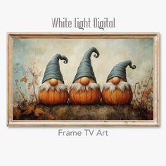 three gnomes sitting on top of pumpkins in front of a white light digital frame