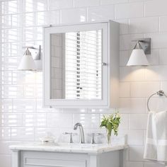 a white bathroom sink sitting under a mirror