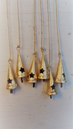 five bells hanging from rope with stars on them