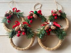 three christmas wreaths hanging from twine rings