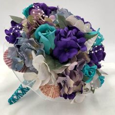 a bridal bouquet with purple and blue flowers