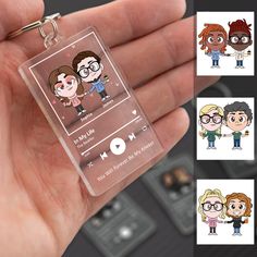 a hand holding a clear keychain with cartoon characters on the front and back