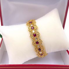 For Sale on 1stDibs - Ruby & Diamond Bracelet Style: Intricate Floral Filigree link Metal: 18K Yellow Gold, 30.31 grams Size & Measurements: 7'' long x 0.65'' (16.3 mm) wide Luxury Ruby Diamond Bracelet For Formal Occasions, Luxury Gold Plated Bracelet For Wedding, Luxury Hallmarked Gold Bracelet For Wedding, Elegant 22k Gold Bracelets For Festive Occasions, Luxury Gold-plated Diamond Wedding Bracelet, Ruby Tennis Bracelet In Yellow Gold For Anniversary, Luxury Red Diamond Bracelet For Weddings, Luxury Gemstone Tennis Bracelet For Wedding, Yellow Gold Ruby Tennis Bracelet For Anniversary