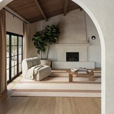 a living room filled with furniture and a fire place next to a doorway that leads to an outside patio