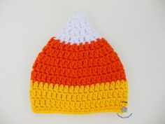 an orange, white and yellow knitted hat