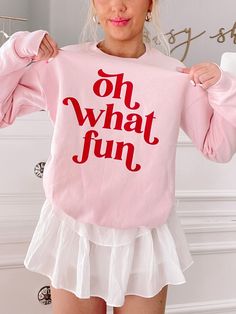 Our Oh What Fun Crewneck is a light pink crew neck with a soft fleece lining on the inside of the sweatshirt. "Oh What Fun" is written in red on the front side. fit : True to size, model wearing a size small Sassy Shortcake, Fancy Fits, Preppy Christmas, Oh What Fun, Holiday Sweatshirt, Pink Crewneck, Christmas Wishlist, Pink Christmas, Christmas Sweatshirts