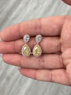 Timeless earrings to last generations featuring 3 carat pear shape drop earrings . Given a stunning contrast surrounded by brilliant white rounds. A classic style to upgrade your everyday look. 3.01 Carat GIA Light Yellow (YZ) Pear VS1 3.03 Carat GIA Light Yellow (YZ) Pear VS2 0.61 & 0.61 Carat GIA G VS1 & VVS1 Pear Surrounded by diamond rounds 7.26 Total Carat Weight Set in Platinum & 18k Gold GIA'S #2366303187 #6251737325 #6224082406 #5222000170 Luxury Yellow Teardrop Earrings, Yellow Diamond Earrings, Yellow Diamond Earring, Pink Halo, Timeless Earrings, Mangalsutra Design, Black Beads Mangalsutra, Black Beads Mangalsutra Design, Yellow Diamond Rings