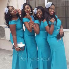 four women in blue dresses posing for the camera