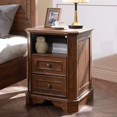 a night stand with two drawers and a lamp