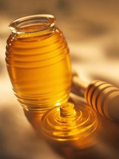 a honey jar sitting on top of a table