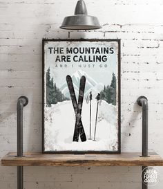 a ski poster hangs on the wall above a wooden shelf with two metal poles and a light fixture