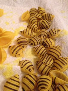 some yellow and black striped pasta shells on a table