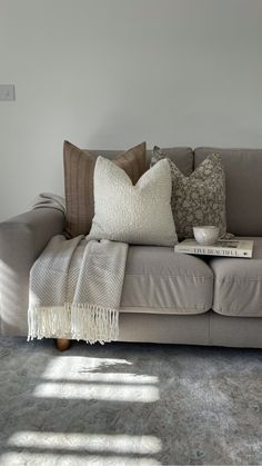 a couch with several pillows on top of it