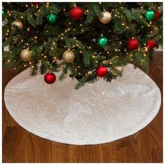 a christmas tree skirt with ornaments on it