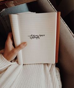 someone is holding a notebook with writing on it and pointing to the page that says, i will always be happy without everything else