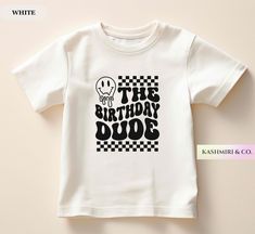 a white t - shirt that says the birthday dude with a skull on it's chest