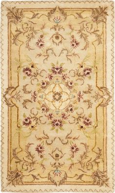 a beige rug with flowers and leaves on the bottom, in an ornate pattern is shown