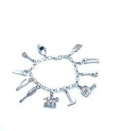 "New. This Bracelet makes a perfect gift  has 11 Handyman Handywoman themed Charms Stainless Steel bracelet has a lobster clasp closure measures approx 8\" bracelet and charms are silver tone alloy and steel." Tools Theme, Handy Woman, Construction Tools, Bracelets And Charms, Steel Bracelet, Charm Bracelets, Stainless Steel Bracelet, Bracelet Making, Lobster Clasp