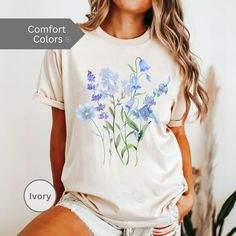 Pressed Flowers Tshirt, Boho Wildflowers Cottagecore Shirt, Oversized Vintage Botanical Tee, Pastel Floral Nature Shirt, Garden Lover Gift Embrace nature's beauty with this stunning blue flowers shirt. This Boho floral shirt is perfect for the free spirit, bringing a touch of the outdoors to your wardrobe. Whether you're a plant and gardening enthusiast or just love a good botanical tee, this Flower T Shirt is a must-have. Designed with a whimsical boho aesthetic, our Boho Flower Shirt features Spring Relaxed Fit T-shirt With Watercolor Print, Oversized Floral Print T-shirt For Spring, Spring Casual T-shirt With Birth Flower, Casual Birth Flower T-shirt For Spring, Blue Casual Watercolor Print Top, Casual Blue Watercolor Print Top, Blue Casual Top With Watercolor Print, Casual Spring Tops With Birth Flower Design, Summer Birth Flower Short Sleeve T-shirt