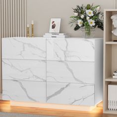 a white marbled dresser in a living room