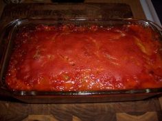 a casserole dish filled with sauce on top of a wooden table