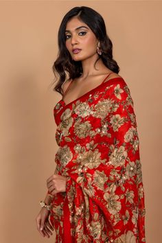 Editor's Note Featuring Varun Bahl's statement floral printed sari highlighted with intricate hand embroidery all over. It is paired with an embroidered corset red blouse. Fabric: Organza Color: Red Component: Sari, blouse and underskirt Sleeve type: Sleeveless Neckline: Sweetheart Fit: Fitted blouse Embroidery details: Hand embroidery Occasion: Festive Blouse length: 14" inches, saree: 5.5 metres, sari width: 45" inches Care: Dry Clean Only About the Designer Varun’s work marries the beauty of Varun Bahl, Cutdana Embroidery, Embroidered Corset, Red Floral Print, Red Saree, Fitted Blouses, Embroidery Blouse, Blouse Online, Saree With Blouse