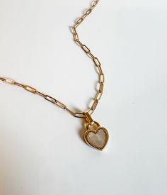 This is the cutest two sided heart, one side has black enamel and the other side white mother of pearl. you can choose a paperclip chain or the curb chain! Either look is a classic all chain and clasp components 14k gold filled and charm is vermiel White Chain Link Jewelry Gift, White Chain Link Jewelry For Gift, Trendy White Double Heart Jewelry, Heart Charm Chain Link Jewelry Gift, Dainty Heart Necklace With Chain For Everyday, Gold Heart Necklace With Paperclip Chain For Everyday, Dainty Gold Heart Necklace With Paperclip Chain, Everyday Paperclip Chain Jewelry For Valentine's Day, Everyday Heart Shaped Tarnish Resistant Chain Necklace