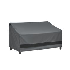 an outdoor furniture cover on top of a bed with black piping and grey trim