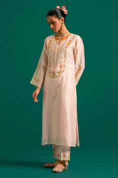 Light pink silk chanderi kurta with placed thread floral embroidery and scalloped edges. Comes with matching pant and contrast green dupatta.
Components: 3
Pattern: Embroidered
Type Of Work: Floral,Sequin
Neckline: Round
Sleeve Type: Full
Fabric: Kurta and Pant: Silk Chanderi, Dupatta: Chanderi
Color: Pink
Other Details: 
Model Height: 5ft 6inches wearing size S
Closure: Kurta: Front hook
Occasion: Mehendi and Haldi - Aza Fashions Bollywood Style Silk Kurta With Floral Embroidery, Transitional Silk Kurta With Floral Embroidery, Semi-stitched Chanderi Kurta With Floral Embroidery, Semi-stitched Silk Kurta With Floral Embroidery, Festive Slub Silk Kurta With Floral Embroidery, Designer Silk Lawn Suit With Cutdana, Festive Silk Salwar Kameez With Floral Embroidery, Embroidered Silk Kurta For Eid, Eid Silk Kurta With Floral Embroidery