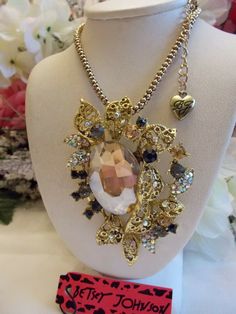 BETSEY JOHNSON LOVELY GOLDEN CENTER RHINESTONE FLORAL ARRAY PENDANT NECKLACE | eBay Gold Jeweled Crystal Necklace In Costume Style, Gold Rhinestone Pendant Necklace For Party, Vintage Gold Crystal Pendant Necklace, Vintage Gold Pendant Crystal Necklace, Glamorous Gold Jeweled Crystal Necklaces, Glamorous Gold Crystal Necklace With Jewels, Long Rhinestone Costume Necklace For Gifts, Glamorous Jeweled Rhinestone Necklace As Gift, Elegant Jeweled Rhinestone Pendant Necklace