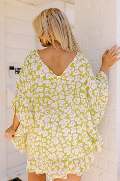 - Perfect for a stylish look on a sunny day, this trendy top will keep you looking fabulous! - Unlined, lightweight material in a green hue with an abstract floral design - A v-cut neckline as well as a v-cut back - Draped half sleeves with ruffle detail - A relaxed silhouette that ends in an uneven ruffled hemline Measurements 1XL : Bust 66", Hip 64", Length 32", Sleeve Length 16.5", Waist 64". 2XL : Bust 68", Hip 66", Length 32", Sleeve Length 17", Waist 66". 3XL : Bust 70", Hip 68", Length 32 V-neck Top With Tropical Print For Brunch, Trendy Green Printed Top, Summer V-neck Blouse With Tropical Print, Tropical V-neck Top With Vibrant Print, Vibrant Print V-neck Top For Brunch, Green V-neck Top With Vibrant Print, Green Printed Tops For Vacation, Tropical V-neck Top For Summer, Green Bohemian Blouse With Vibrant Print