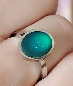 This is a beautiful mood ring. Changes color with your mood. Band is stainless steel which will never tarnish, rust, or change color. And is hypoallergenic! Pair up with any of my name rings. I ship out in 1-2 business days and guarantee customer satisfaction. Hypoallergenic Stainless Steel Rings, Green Stainless Steel Ring As A Gift, Green Stainless Steel Rings For Gifts, Green Stainless Steel Rings As Gifts, Green Stainless Steel Ring For Gift, Nickel-free Green Stainless Steel Jewelry, Nickel-free Stainless Steel Round Rings, Iridescent Nickel-free Ring For Gift, Retro Green Ring For Gift