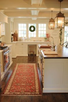 a kitchen with an area rug on the floor