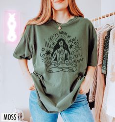 Channel your inner peace with this inspired yoga tee - featuring a hand drawn graphic of a woman with flowing shapes that celebrate movement, mindfulness, and wellness on and off the mat. We use professional quality DGT printing on all our apparel. Direct-to-garment, or DTG, is a high quality printing method that sprays ink directly onto the garment so there is no peeling or cracking. This fabulous graphic will be printed on a Comfort Colors Unisex T-Shirt. Please refer to the size charts in the images for the best fit.  Estimated Production Time: 1-5 days Estimated Shipping Time: 2-5 days 100% cotton shirt  Machine wash: cold  Non-chlorine: bleach as needed Tumble dry: low heat Iron, steam or dry: medium heat Do not dry clean Yoga Lover Gift, Lotus Pose, Yoga Tees, Yoga Shirt, Yoga Instructor, Tee Shirt Designs, Yoga Shirts, Size Charts, Inner Peace