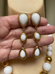 "You must have at least one set of white jewelry just for summer. White pearls don't count. I'm talking fun stuff. Necklace is signed Napier and earrings signed Trifari. Necklace will extend from 16 to 18\" with a hook clasp. Largest front beads are about 18 and 20mm round. They continue to be fairly big at about 10mm near clasp. Earrings are clip backs marked Trifari. Big look at 3\" but the largest section is against the earlobe. Not heavy anyway but I think the largest bead at top is a good i Pearl White Clip-on Jewelry, Modern White Clip-on Jewelry, Elegant White Necklaces With Matching Earrings, Elegant White Drop Jewelry, White Round Clip-on Jewelry, Modern White Teardrop Necklace, White Pearl Drop Costume Jewelry, White Round Jewelry With Matching Earrings, White Jewelry With Matching Earrings