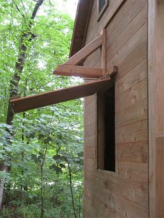 an open window on the side of a wooden building