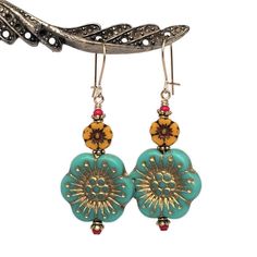 "Large, colorful Anemone flower earrings in a retro shades of aqua and marigold.  Detailed, European pressed-glass flower beads are matched with tiny, vintage, ruby red seed beads.   22K gold-plated spacers add texture to a look which is lively and fun. Quality 14K gold-filled ear wires - choose from kidney or French.  14K gold-filled head pins.  Length is 1 7/8\". All my Etsy jewelry offerings are designed and created by me.  As an independent craftsperson, I value your patronage.  Please use c Yellow Flower-shaped Retro Jewelry, Retro Yellow Flower Jewelry, Retro Yellow Flower-shaped Jewelry, Vintage Flower Charm Dangle Earrings, Retro Flower-shaped Earrings For Gift, Retro Flower Earrings For Gift, Retro Flower Shaped Earrings For Gift, Retro Flower Shaped Earrings As Gift, Retro Multicolor Flower Earrings For Gift