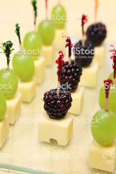 grapes and cheese are arranged on skewers with toothpicks in the form of fruit