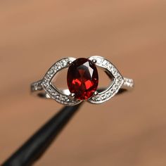 a ring with a large red stone in it