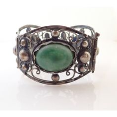 Up for sale is a Vintage Mexico Jade Cabochon Sterling Silver Repousse Filigree Bracelet. Bracelet measures approx. 6 3/4" by 1 5/8" wide. Weighs 61.6 grams. Jade stones measure approx. 1" by 3/4" each. Sterling will polish nicely. Nice vintage condition. Comes exactly as shown. Please ask any questions before buying.  I Vintage Cabochon Bracelets For Formal Occasions, Vintage Green Cuff Bracelet For Formal Occasions, Vintage Green Cuff Bracelet For Formal Events, Green Vintage Cuff Bracelet For Formal Occasions, Green Vintage Formal Cuff Bracelet, Vintage Cabochon Bangle Bracelet, Vintage Cabochon Bangle Bracelets, Vintage Cabochon Cuff Bangle, Vintage Silver Cabochon Cuff Bracelet