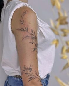 a woman's arm with a flower tattoo on the left side of her arm